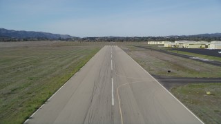 DFKSF01_065 - 5K aerial stock footage tilt from vineyard to reveal runway, approach for landing, Santa Ynez Airport, California