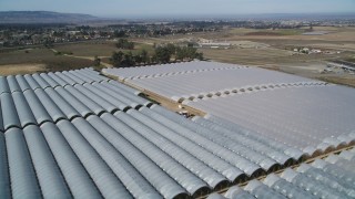 DFKSF02_003 - 5K aerial stock footage of flying over greenhouses at a farm in Santa Maria, California