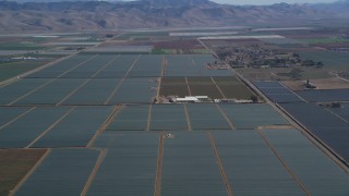 DFKSF02_005 - 5K aerial stock footage of flying by a rural landscape of crop fields, Santa Maria, California