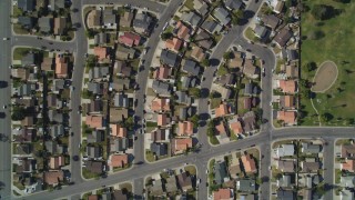 DFKSF02_009 - 5K aerial stock footage of a bird's eye view of tract homes, revealing farm fields, Santa Maria, California