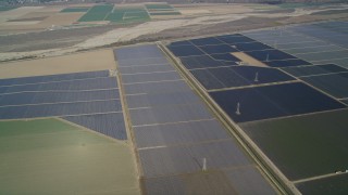 DFKSF02_012 - 5K aerial stock footage of tilting to a bird's eye view of fields of crops, Santa Maria, California