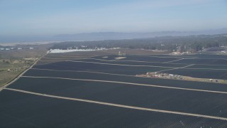 DFKSF02_016 - 5K aerial stock footage of flying over crop fields in rural landscape, Nipomo, California