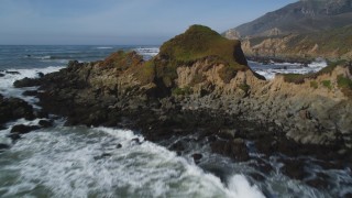 DFKSF02_064 - 5K stock footage aerial video fly over waves, rock formations, tilt to reveal coastal cliffs, Avila Beach, California