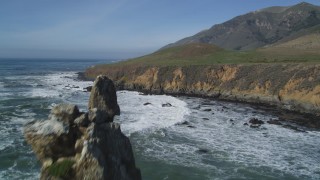 DFKSF02_065 - 5K stock footage aerial video fly over coastal cliffs, reveal rock formations off the coast, Avila Beach, California