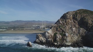 DFKSF03_004 - 5K stock footage aerial video of the Dynegy Power Plant and smoke stacks, reveal Morro Rock, Morro Bay, California