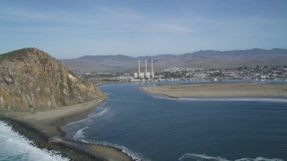 DFKSF03_006 - 5K aerial stock footage of a view of Morro Rock and the Dynegy Power Plant with smoke stacks, Morro Bay, California
