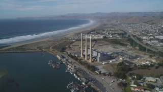 DFKSF03_008 - 5K aerial stock footage of flying by the coastal Dynegy Power Plant with smoke stacks, Morro Bay, California