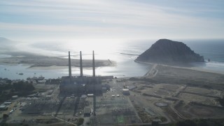 DFKSF03_010 - 5K stock footage aerial video of flying by Dynegy Power Plant and Morro Rock in Morro Bay, California