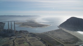 DFKSF03_012 - 5K aerial stock footage of flying by Dynegy Power Plant, Morro Rock, coast, harbor in Morro Bay, California