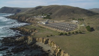 DFKSF03_017 - 5K stock footage aerial video of flying by a coastal abalone farm, Cayucos, California