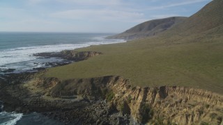 DFKSF03_024 - 5K aerial stock footage of flying over the green coastline, Harmony, California