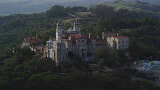 DFKSF03_065 - 5K aerial stock footage of flying by the east side of Hearst Castle, San Simeon, California