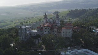 DFKSF03_066 - 5K aerial stock footage of flying by the east and north side of historic Hearst Castle, San Simeon, California