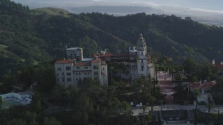 DFKSF03_067 - 5K aerial stock footage of flying by north side of famous Hearst Castle, revealing Neptune Pool, San Simeon, California
