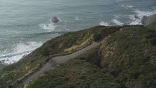 DFKSF03_087 - 5K stock footage aerial video track white convertible on Highway 1, above coastal cliffs, Big Sur, California