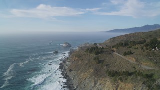 DFKSF03_092 - 5K aerial stock footage of approaching a large rock formation off the coast, Big Sur, California