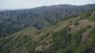 DFKSF03_136 - 5K aerial stock footage of flying over green mountains in Los Padres National Forest, California