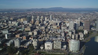 DFKSF05_002 - 5K aerial stock footage approach and pan across city buildings in Downtown Oakland, California