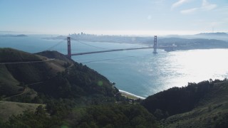 DFKSF05_050 - 5K aerial stock footage fly over Marin Hills to reveal Golden Gate Bridge, an iconic landmark, San Francisco, California