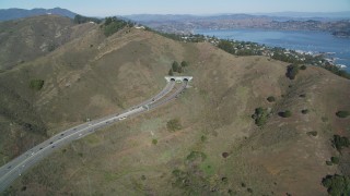 DFKSF05_053 - 5K aerial stock footage of approaching Robin Williams Tunnel (Waldo Tunnel), Marin Hills, Sausalito, California