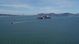 DFKSF05_068 - 5K aerial stock footage of iconic Alcatraz with a view of the famous Golden Gate Bridge, San Francisco, California
