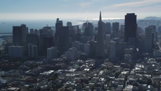 DFKSF05_075 - 5K aerial stock footage fly over Coit Tower, approach Transamerica Pyramid and skyline, Downtown San Francisco, California