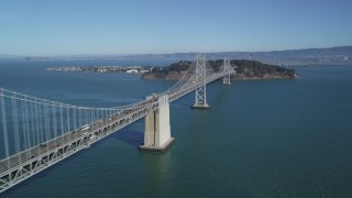 DFKSF05_088 - 5K aerial stock footage of flying by the Bay Bridge with light traffic, San Francisco, California