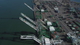 DFKSF05_093 - 5K aerial stock footage of flying over four cargo cranes at the Port of Oakland, California