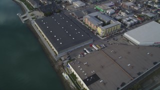 DFKSF06_004 - 5K aerial stock footage bird's eye of factories, warehouses, apartment buildings between bridges, Oakland Estuary, California