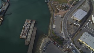 DFKSF06_005 - 5K aerial stock footage of waterfront warehouses and factories, reveal Union Point Park, Oakland Estuary, California