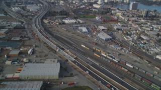 DFKSF06_008 - 5K stock footage aerial video of flying by I-880 freeway and a train yard, Oakland, California