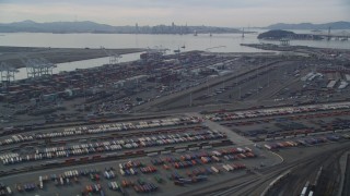 DFKSF06_013 - 5K stock footage aerial video tilt from I-880 freeway, revealing the Port of Oakland, California
