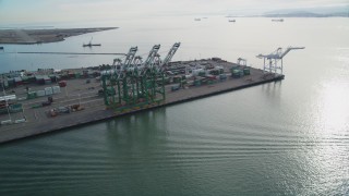 DFKSF06_020 - 5K aerial stock footage of orbiting the cargo cranes and shipping containers at the Port of Oakland, California