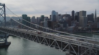 DFKSF06_025 - 5K aerial stock footage track light traffic on the Bay Bridge with views of Downtown San Francisco, California