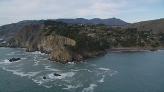 DFKSF06_104 - 5K aerial stock footage of flying by hillside homes on coastal cliffs in Muir Beach, Marin County, California