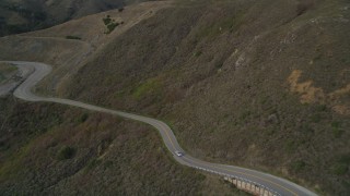 DFKSF06_108 - 5K aerial stock footage of flying over Highway 1 at the base of mountains, Marin County, California