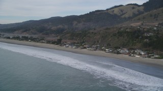 DFKSF06_115 - 5K aerial stock footage of flying by beachfront homes and coastal hills, Stinson Beach, California