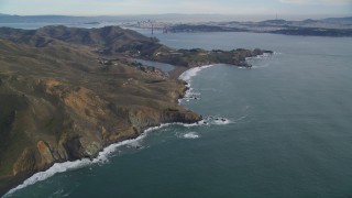 DFKSF06_153 - 5K stock footage aerial video of flying by Marin Headlands, San Francisco in the distance, Marin County, California