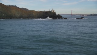 DFKSF06_160 - 5K stock footage aerial video fly over the Point Bonita Lighthouse revealing Golden Gate Bridge, San Francisco, California