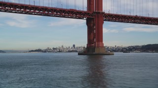 DFKSF06_163 - 5K aerial stock footage fly under Golden Gate Bridge to approach Downtown San Francisco skyline, California