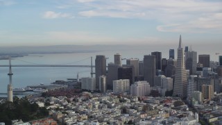 DFKSF06_174 - 5K aerial stock footage of Coit Tower, Transamerica Pyramid and skyscrapers, Bay Bridge, Downtown San Francisco, California