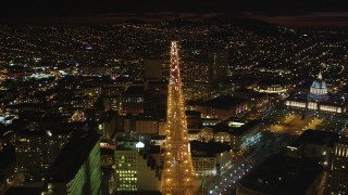 DFKSF07_006 - 5K aerial stock footage of flying over Market Street through Civic Center near city hall, San Francisco, California, night
