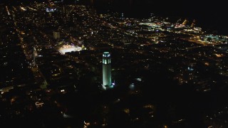 DFKSF07_020 - 5K aerial stock footage of flying by Coit Tower in North Beach, San Francisco, California, night