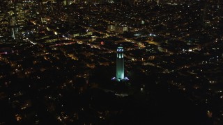 DFKSF07_021 - 5K aerial stock footage orbit Coit Tower, to reveal skyscrapers in Downtown San Francisco, California, night