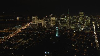 DFKSF07_022 - 5K aerial stock footage of Coit Tower and the city's skyscrapers, Downtown San Francisco, California, night