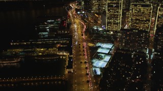 DFKSF07_023 - 5K aerial stock footage of flying over the Embarcadero near skyscrapers in Downtown San Francisco, California, night