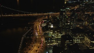 DFKSF07_024 - 5K aerial stock footage following the Embarcadero between Ferry Building and Downtown San Francisco skyscrapers, California, night