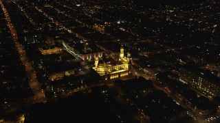 DFKSF07_044 - 5K aerial stock footage tilt to reveal St. Ignatius Church in the Inner Richmond District, San Francisco, California, night