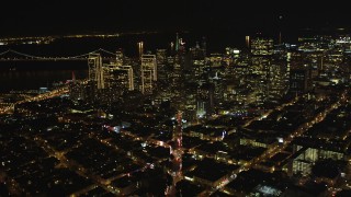DFKSF07_058 - 5K aerial stock footage of tilting from Columbus Ave to reveal skyscrapers in Downtown San Francisco, California, night