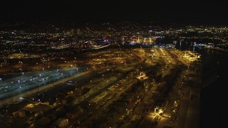 DFKSF07_078 - 5K aerial stock footage video of flying over rows of containers at the Port of Oakland, California, night